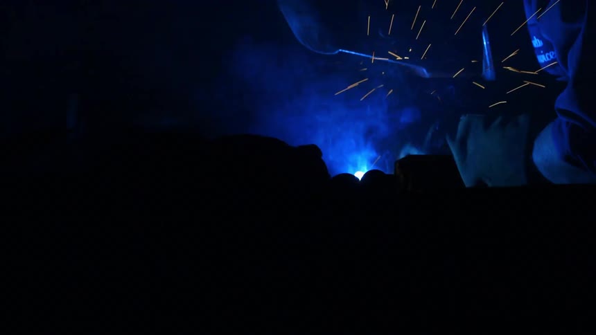 Person welding with sparks flying up