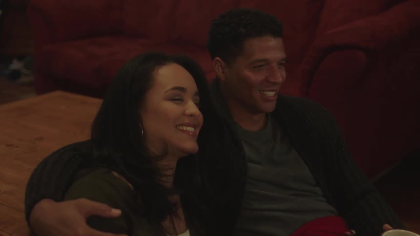 A man and woman sit and talk together