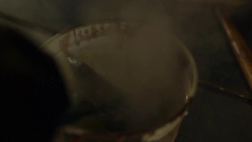 Hot metal is placed into a bucket of water and steam rises