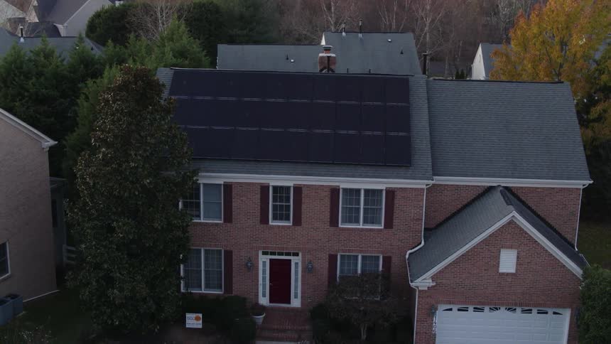 Solar panels sit on the roof of a house