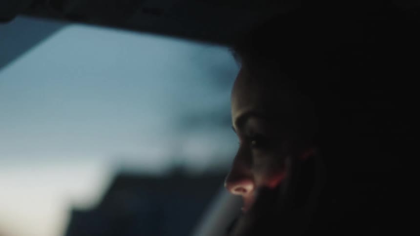 Woman sitting in a vehicle talking on a phone