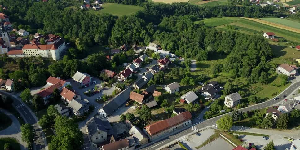 Cars drive on the road in this small town