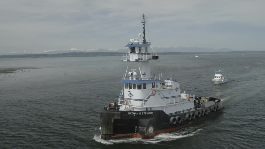 Subtle orbiting ascent around a large tugboat returning from sea