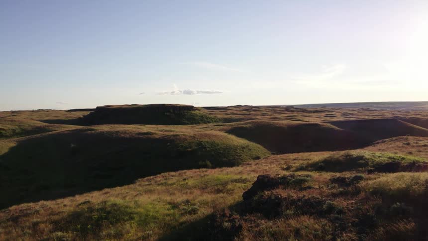 Rugged contoured landscape and rangeland ascent reveal