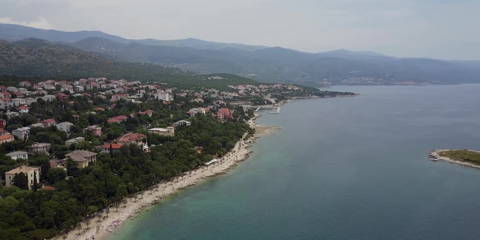 Houses next to a beach and large body of water