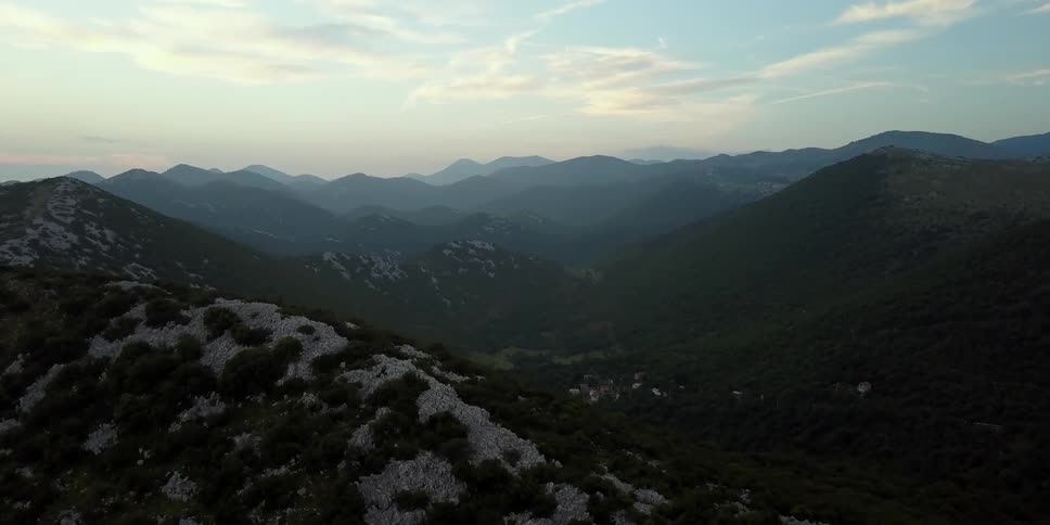 Clouds float over a hilly mountain valley