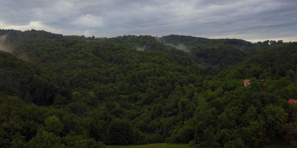 The row of hills have some houses built on some of the peaks