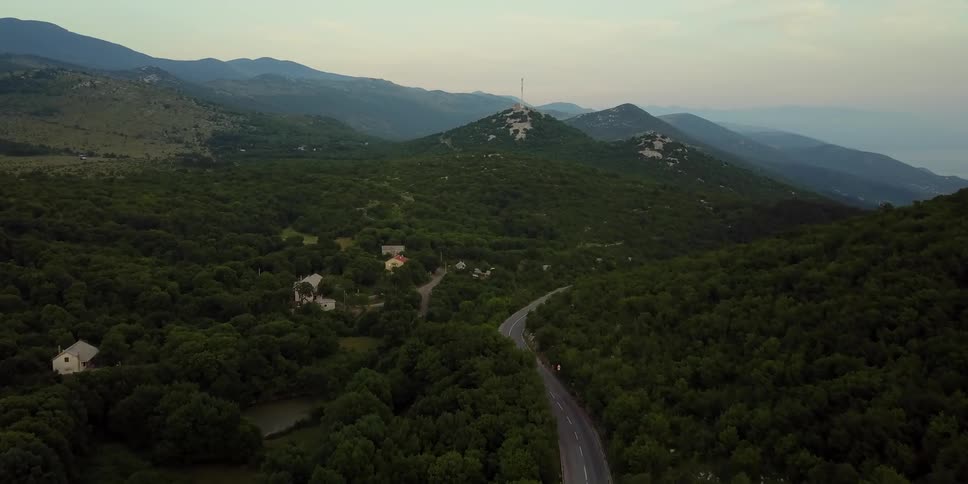 A car drives on a road in the mountains