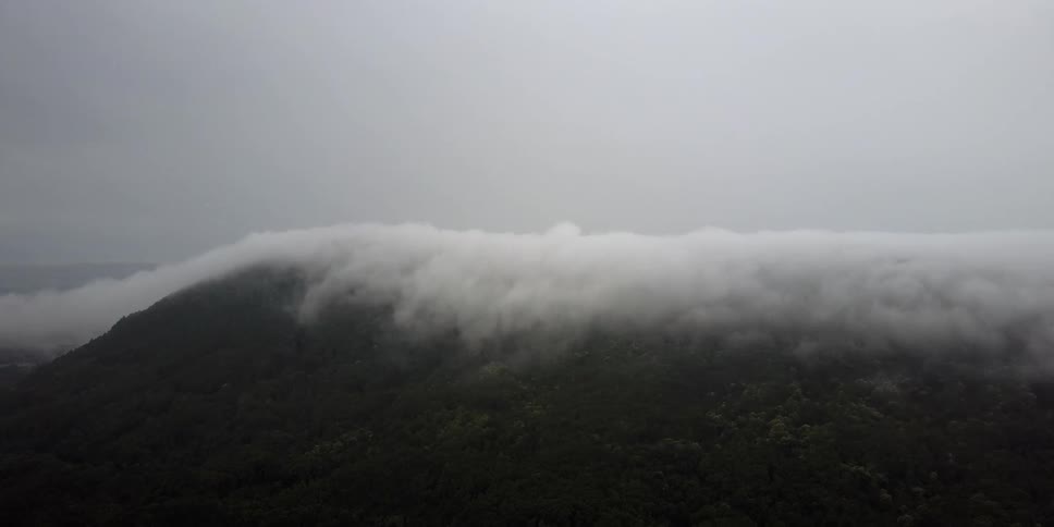 Fog slowly rolls over the hill ahead