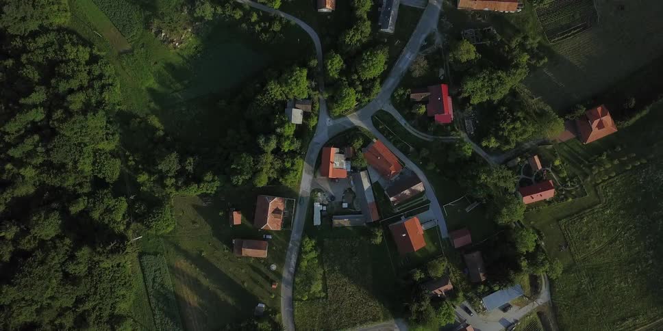 A small town below has a small winding road