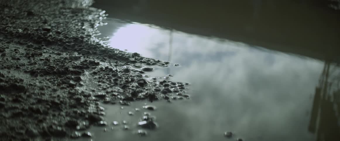 Water ripples on a muddy puddle