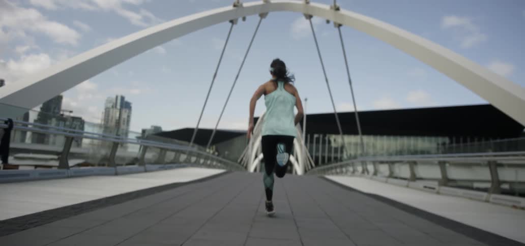 Woman jogging on a city pathway