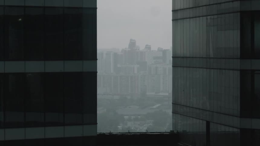 From the rooftop you can see a city in the fog