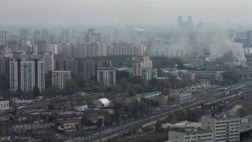 Smoke billows around city buildings and skyscrapers