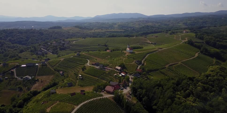 A small farming community is shown on a sunny day