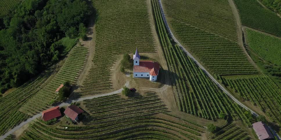 A building sits on a hill in a small farming community