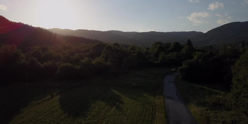 The sun sets over a mountain valley