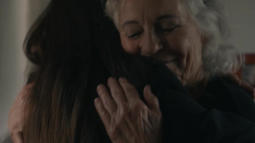 Two women talk then have a big hug