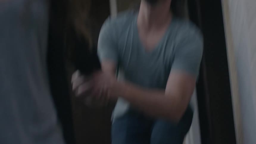 Woman leaving a house and a man grabs her arm pleading