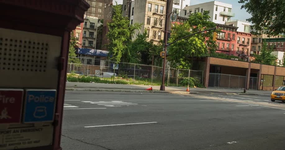 This is a busy city street with people walking and cars driving