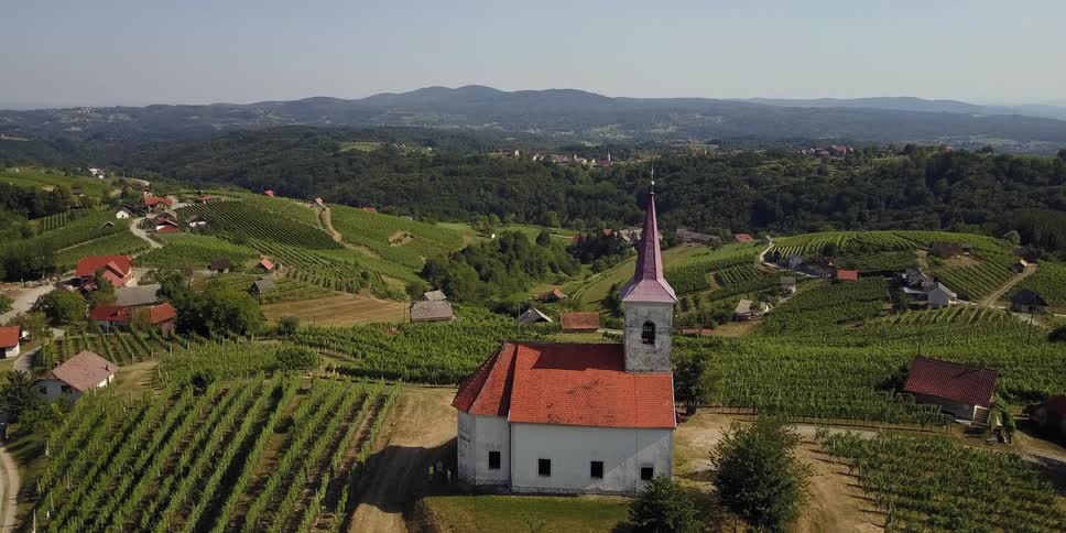 Church on a hilltop with houses scattered nearby