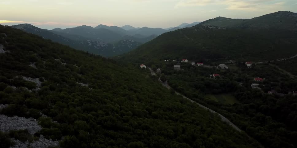 The hills are high and covered with rocks and grass