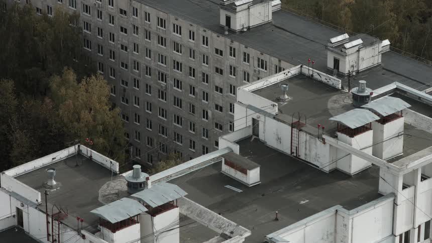 A housing building is white and grey in color