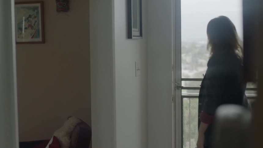 A woman gives a kiss to her female partner as she leaves the house