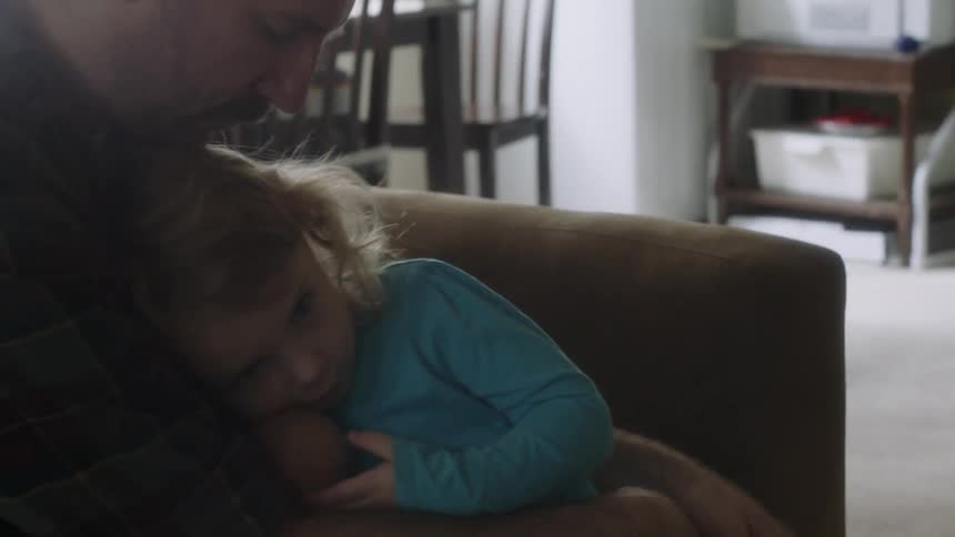 A man gives his child a hug