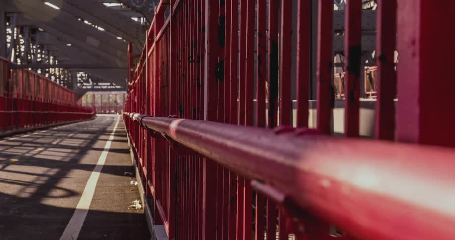 People run and walk across a bridge