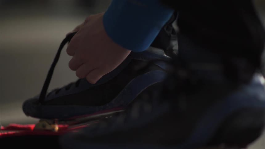 A person ties their shoelace