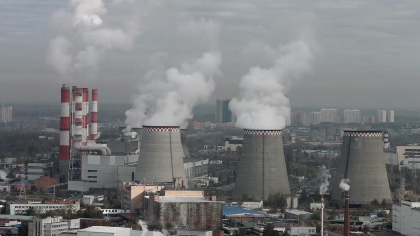 Smoke rises from a factory in a city