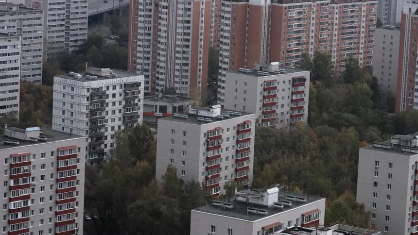 View of tall apartment buildings with a highway behind it