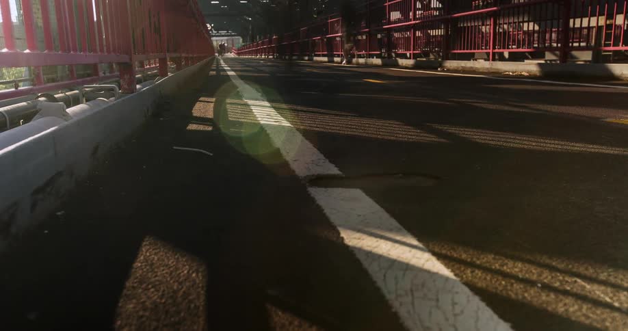 Pedestrians and bicyclists cross a city bridge