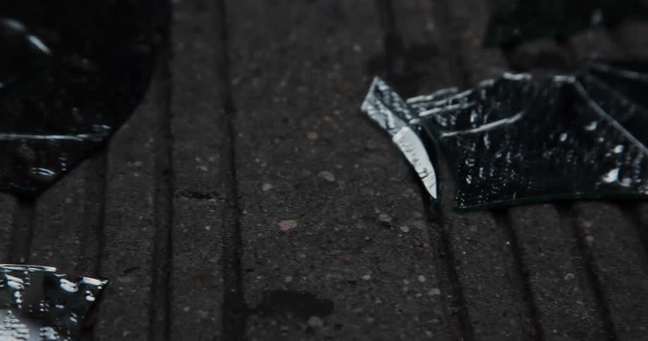 Shards of glass cover the concrete ground