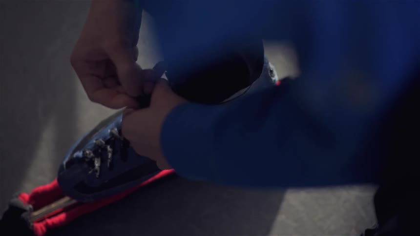 A person is tying up his boots