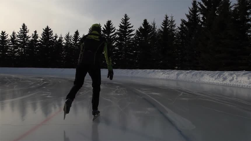 A man is ice skating on a cloudy day