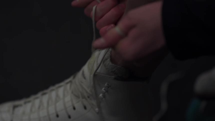 A person is tying their skates