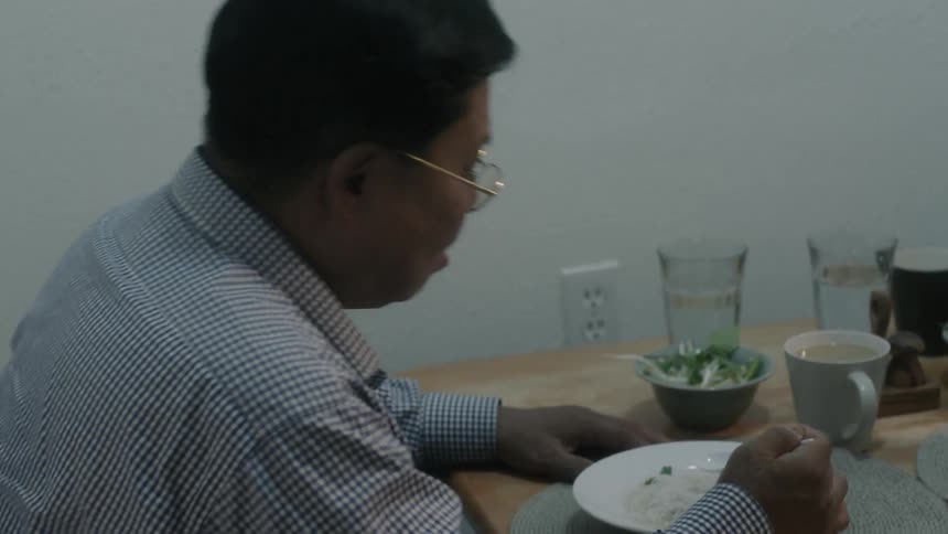 A man is eating from a bowl