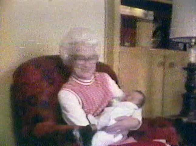 A woman cradles a baby in her arms