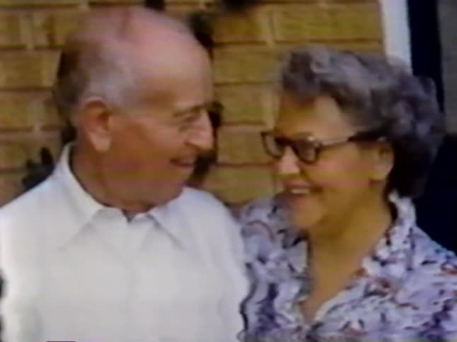 A man and woman talk together and laugh