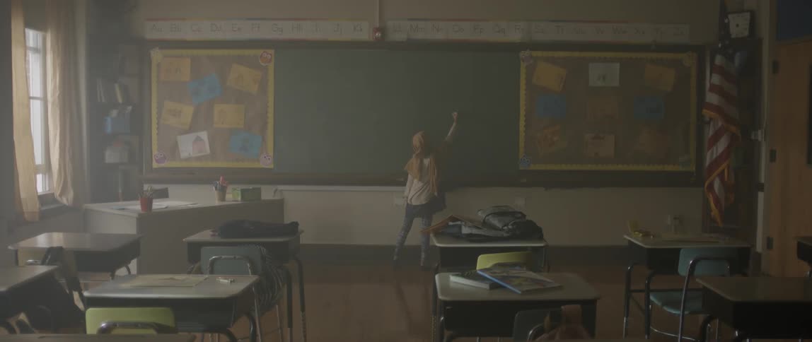 A child is writing on the blackboard