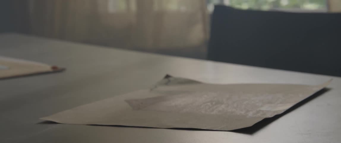 A sheet of paper blows on the table falling