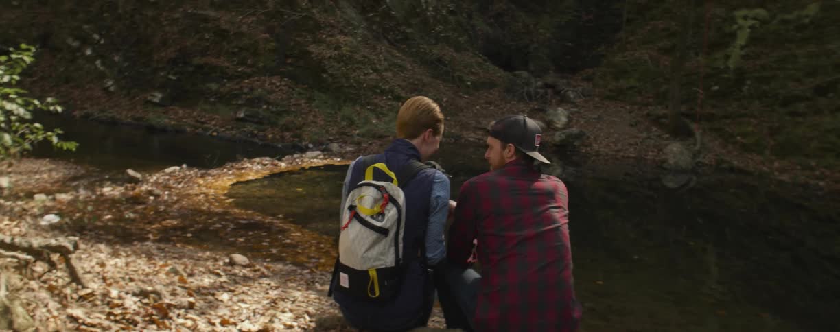 A couple of people sitting next to a water spot laughing and talking