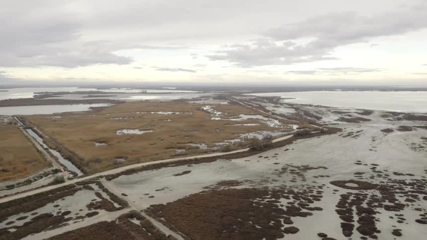 Aerial view of snow covered plains on a cloudy day