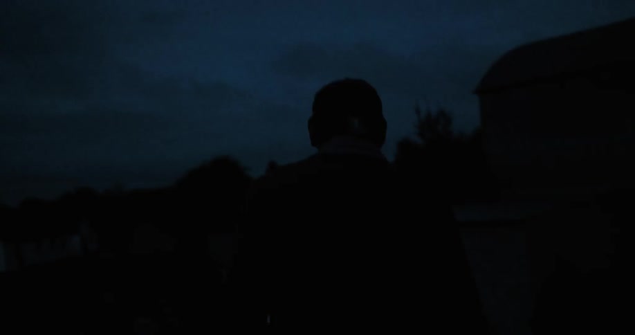 A man is walking in the dark
