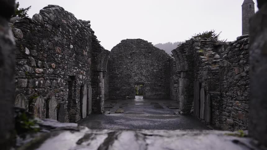 Rain falls on the ruins of a stone building