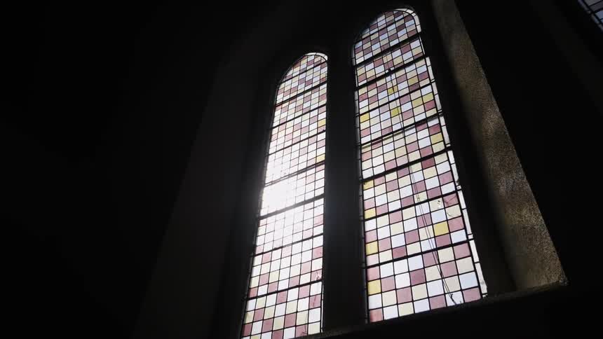 A stained glass window inside a building