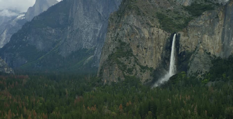 A waterfall is on the side of this large mountain