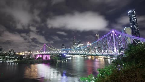 Time lapse of clouds floating over a city at night